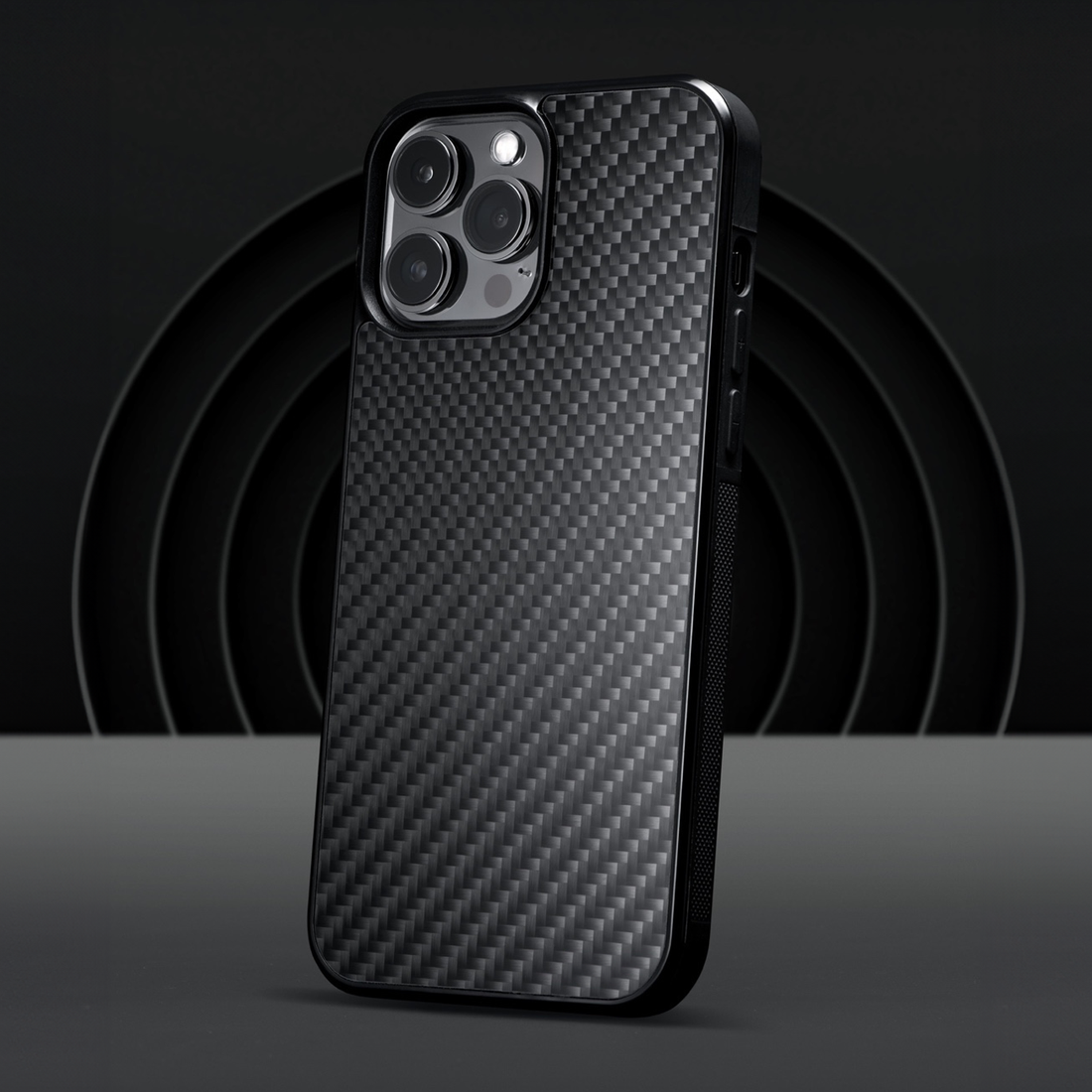 Classic black carbon fiber iPhone case in dark studio setup