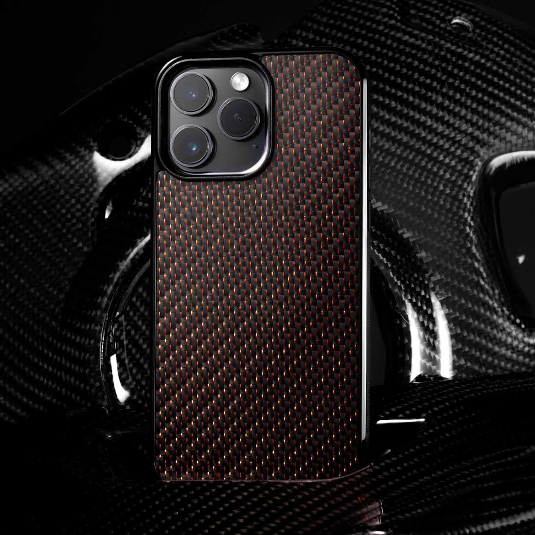 Premium red carbon fiber iPhone case in dark studio lighting