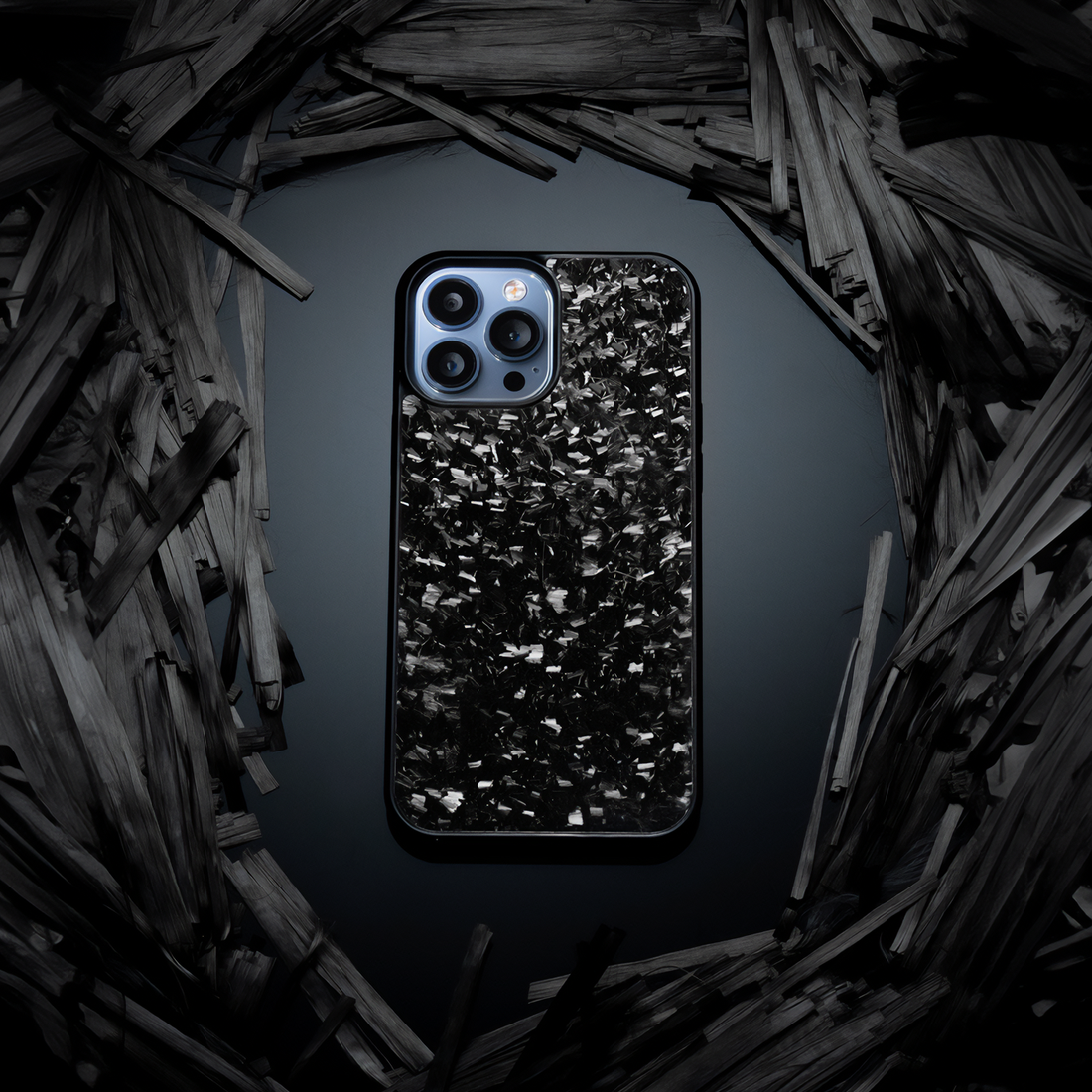 iPhone with forged carbon case surrounded by carbon shards, dark setup