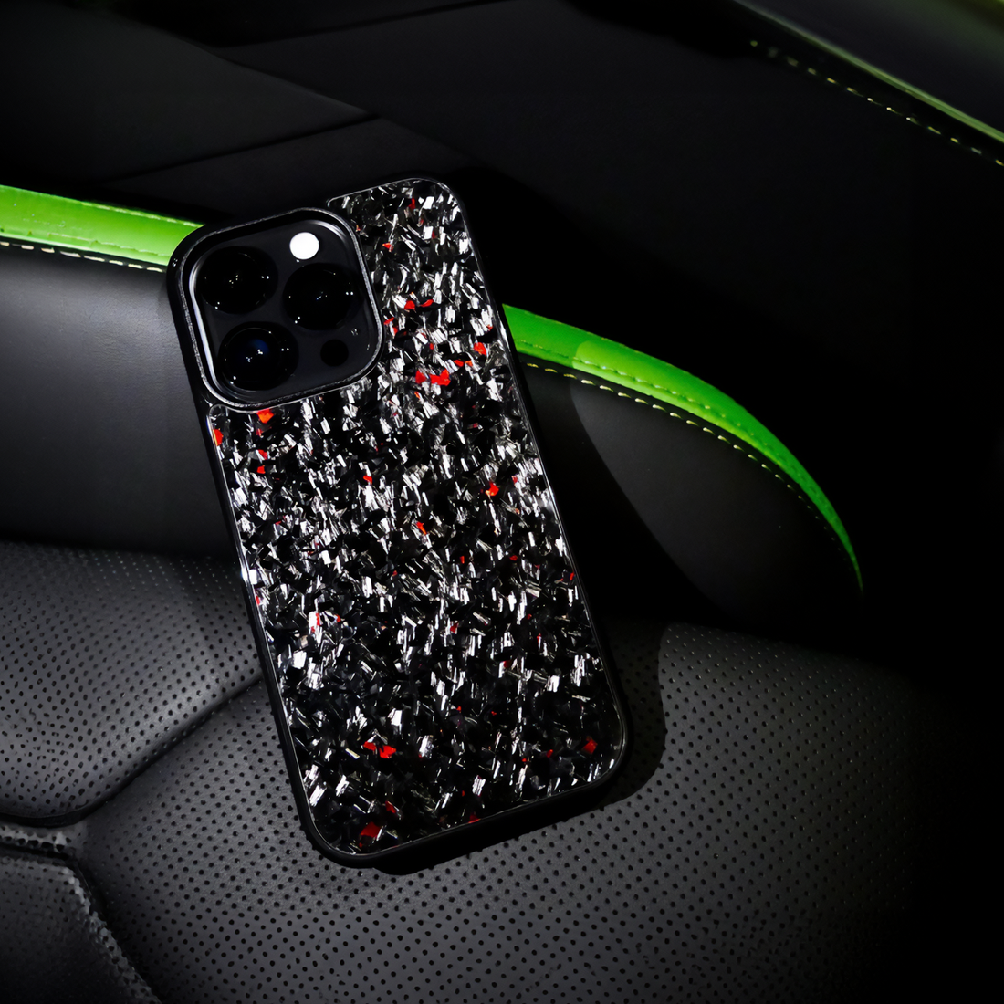 Forged carbon case with red accents on luxury car seat, green light contrast